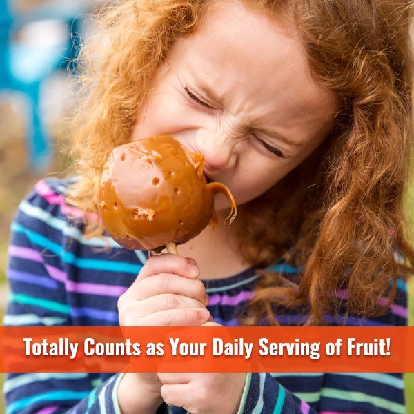 Young girl biting into a caramel apple with the text “Totally counts as your daily serving of fruit!”